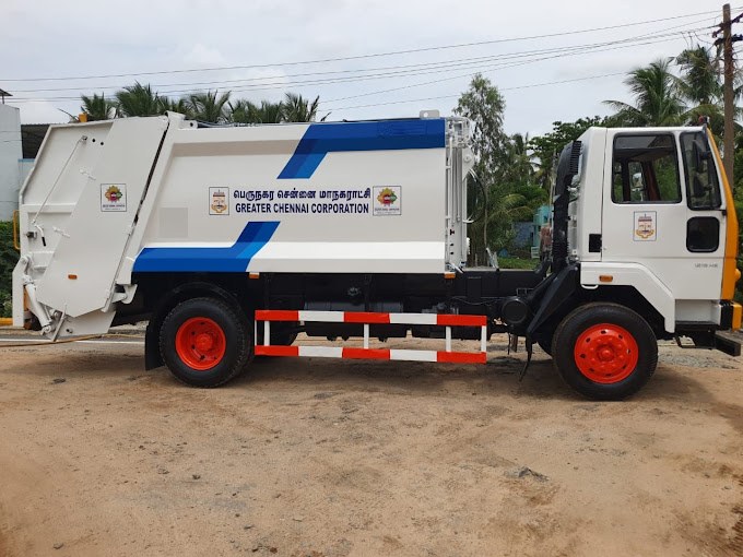 Refuse compactor truck parked at a municipal depot