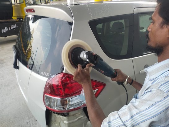 Polishing work being carried out on a vehicle body panel